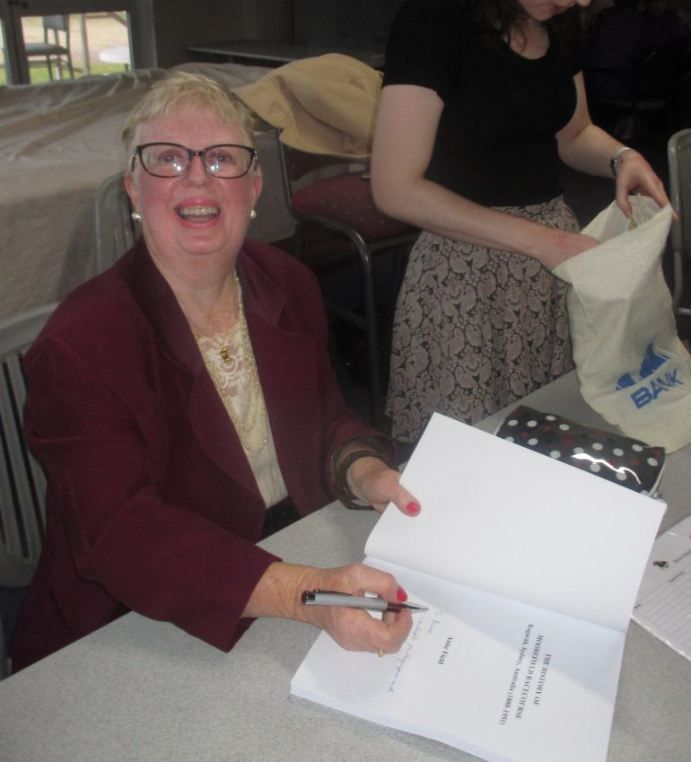 Anne signing the book